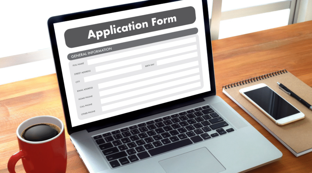 Online business school application form displayed on a laptop screen.